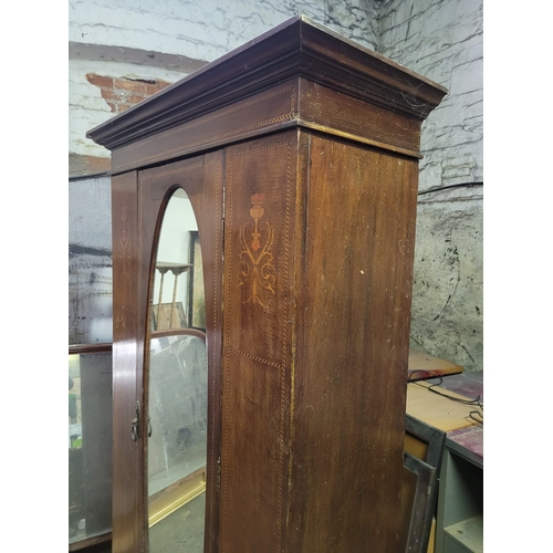 11 - AN EDWARDIAN SINGLE DOOR WARDROBE WOTH FEATHER INLAY, OVAL MIRRORED DOOR,
AND SINGLE DRAWER. FULL SE... 