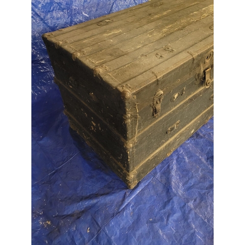 19 - A VERY LARGE ANTIQUE TRAVEL TRUNK. A SIZEABLE DARK CHEST WITH ORIGIANL METAL
HANDLES, METAL BANDING ... 