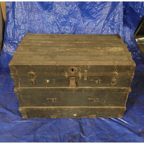 19 - A VERY LARGE ANTIQUE TRAVEL TRUNK. A SIZEABLE DARK CHEST WITH ORIGIANL METAL
HANDLES, METAL BANDING ... 