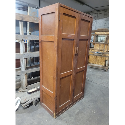 20 - A TALL MID CENTURY PINE DOUBLE DOORED SHELVED LOCKER. IRON HINGES,GOOD
MELLOW COLOUR. EX CHRISTIANS ... 