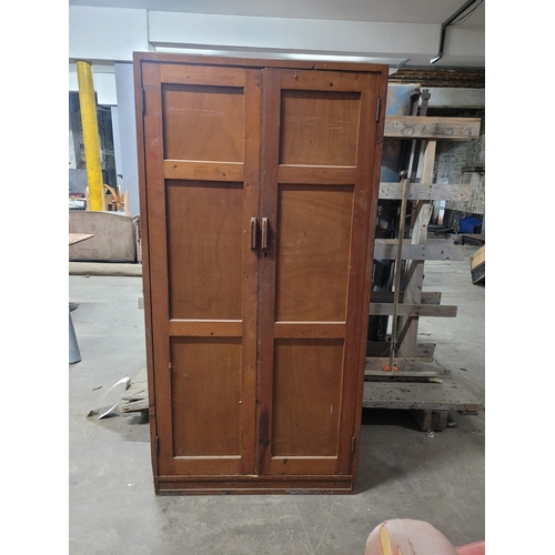 20 - A TALL MID CENTURY PINE DOUBLE DOORED SHELVED LOCKER. IRON HINGES,GOOD
MELLOW COLOUR. EX CHRISTIANS ... 