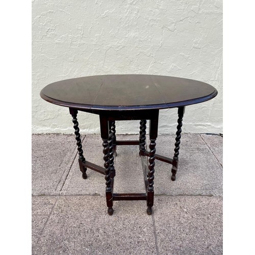 6 - An 1800s gateleg table with barley twist legs