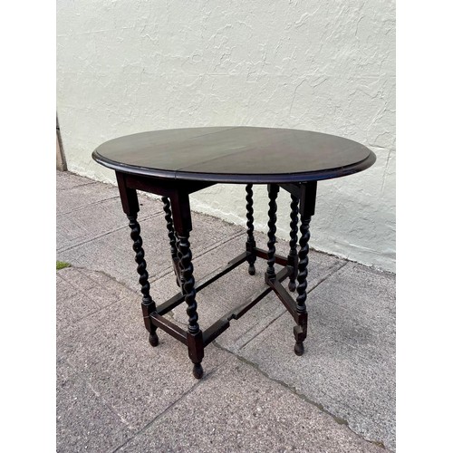 6 - An 1800s gateleg table with barley twist legs