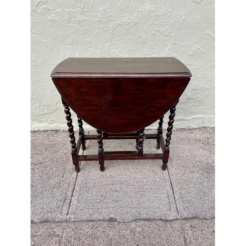 6 - An 1800s gateleg table with barley twist legs