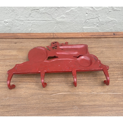 72 - Cast metal coat hanger with tractor design