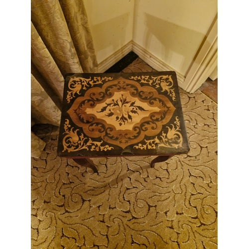 414 - A small side occasional table with marquetry inlay and musical mechanism. Damaged top