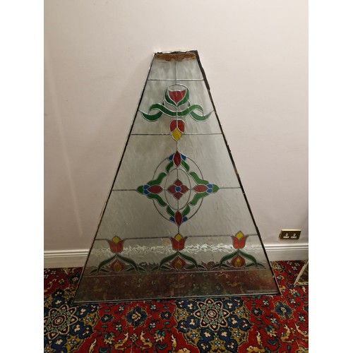 30 - A large triangular stained glass panel.
Dimensions approximate. W 53'' H 57.5'' Top 9'' 2'' thick