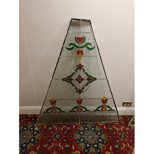 33 - A large triangular stained glass panel.
Dimensions approximate. W 53'' H 57.5'' Top 9'' 2'' thick