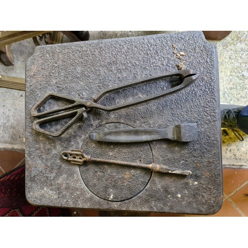 77 - A cast iron stove and implements