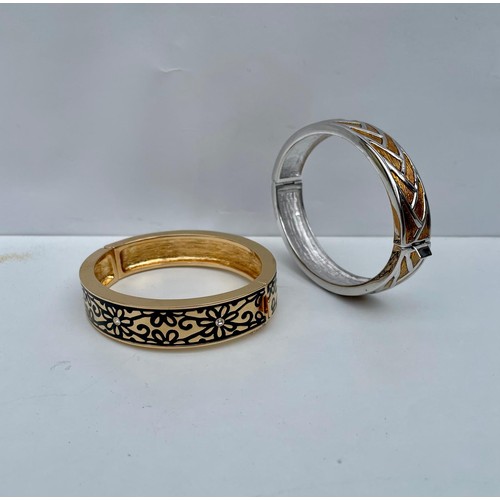 97 - Pair of gold and silver tone bangle bracelets