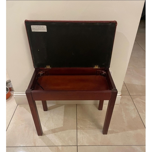 122 - A smart burgundy piano stool