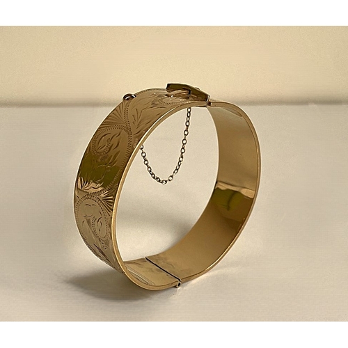 16 - A gold clasped bangle bracelet. Gold plated with bronze core.