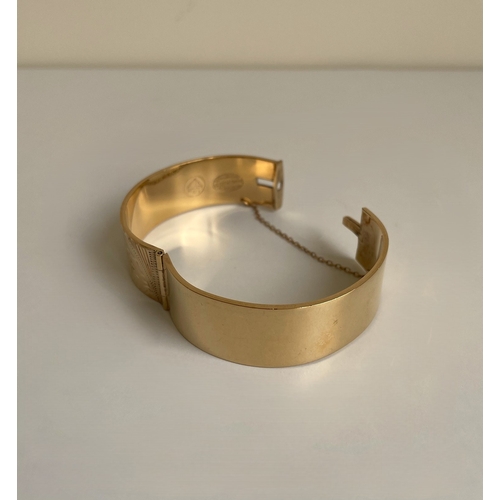 16 - A gold clasped bangle bracelet. Gold plated with bronze core.