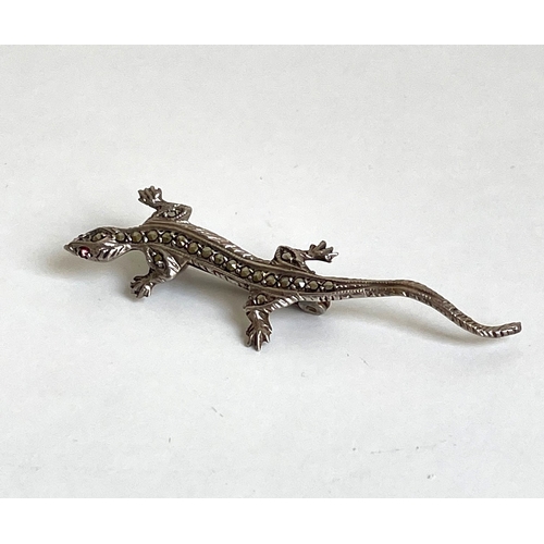 18 - A silver iguana brooch with stone set eyes.