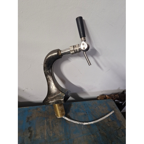 29 - A large stainless steel European style beer tap.