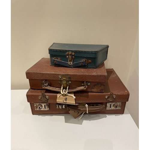 339 - A set of three vintage leather suitcases.