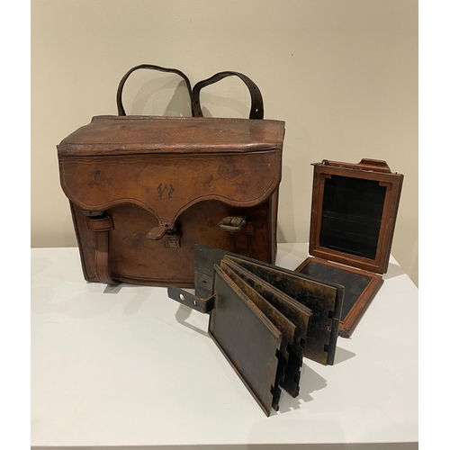 340 - An antique camera case and camera slide folders.