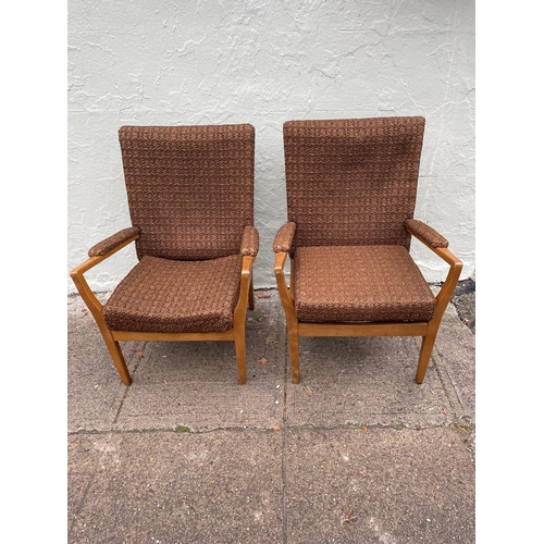 121 - A pair of teak 1960s fireside chairs.