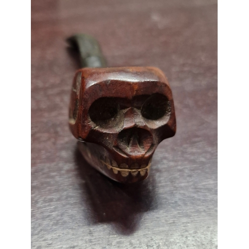 24 - A cast iron paper weight and a skull designed pipe. Made in Italy