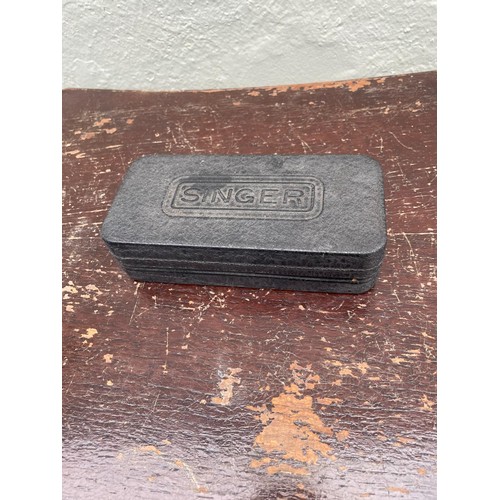 188 - Singer spare parts and singer case