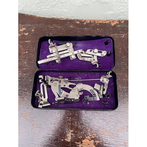 188 - Singer spare parts and singer case