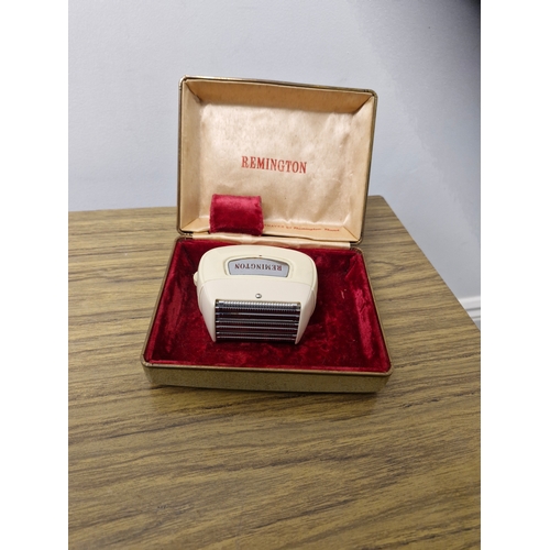 219 - A vintage Remmington electric shaver.