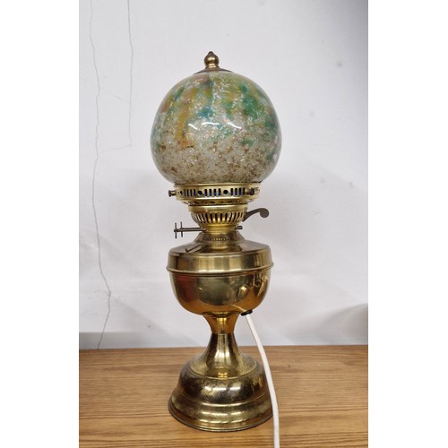 241 - A brass lamp with a very interesting and highly decorative lamp shade.