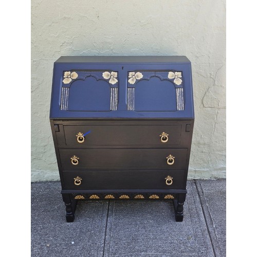 97 - An early 1900s oak carved bureau with black and gold decorative features
