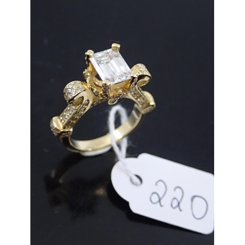220 - A ladies 18ct gold emerald cut diamond ring with diamond shoulders finger size K