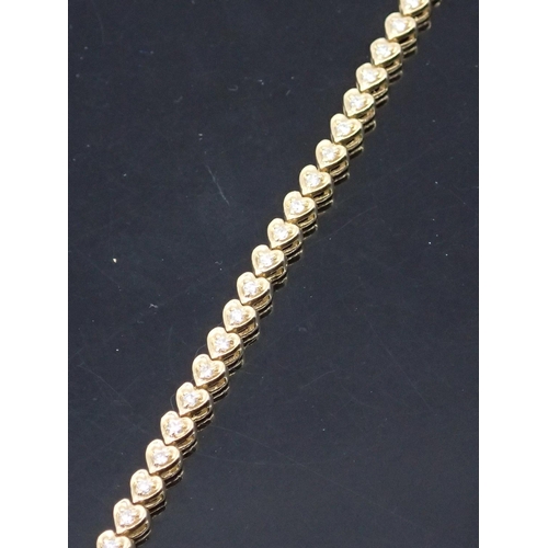 34 - A diamond line bracelet set in 14kt gold approx.11.3 grams 7 inches in length