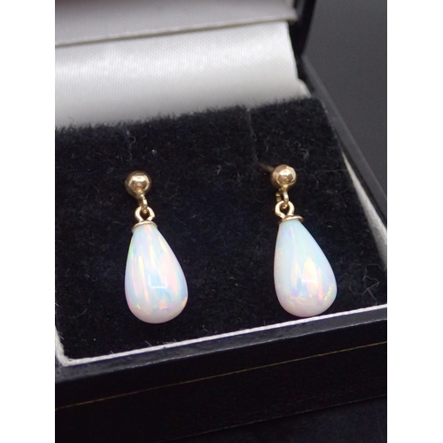 102 - A pair of 9ct gold opal style drop earrings