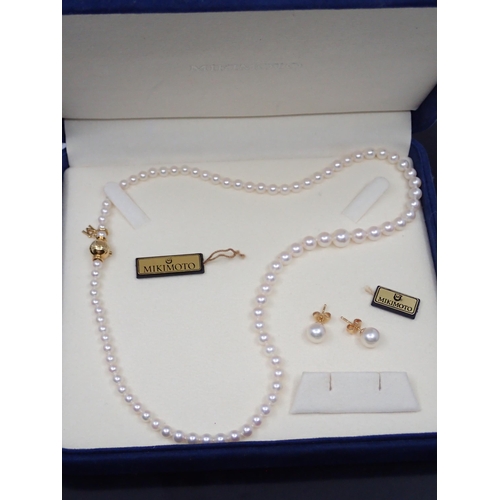 112 - A set of Mikimoto pearls (gold clasp set with a diamond) and a set of 18ct gold earrings