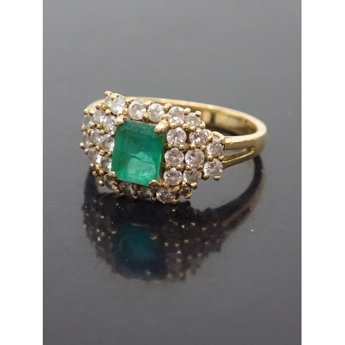 120 - An emerald and diamond cluster ring set in 18ct gold finger size nearly N