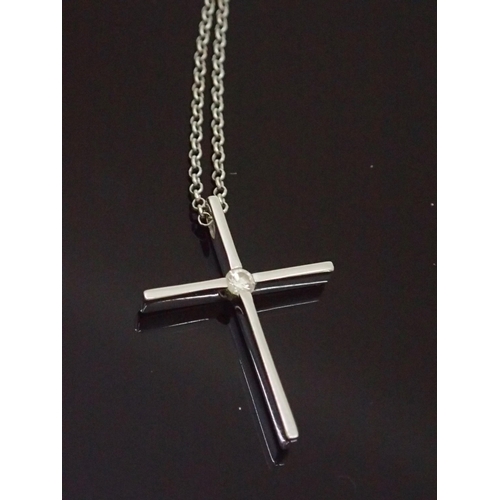 140 - A diamond set 18ct gold cross on chain approx. 6 grams