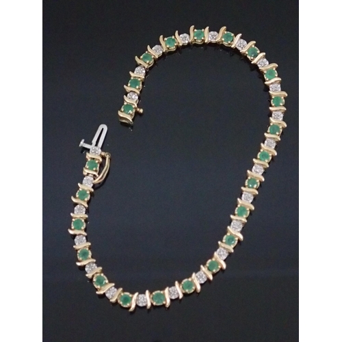 144 - A diamond and emerald set 9ct gold bracelet approx. 6 grams