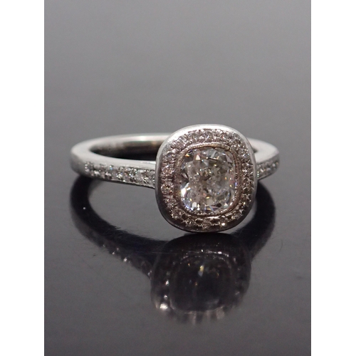 148 - A fine diamond halo style ring with a GIA certificate which states the main diamond is cushion brill... 