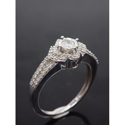 153 - A white gold diamond cluster ring, showing as finger size P