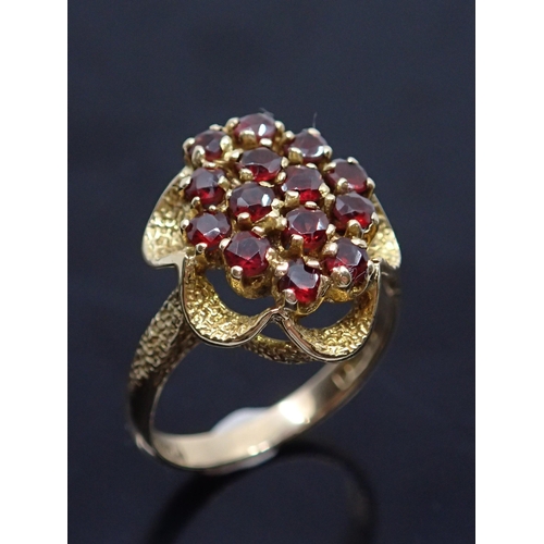 154 - A 9ct gold garnet cluster ring, showing as finger size L and a half