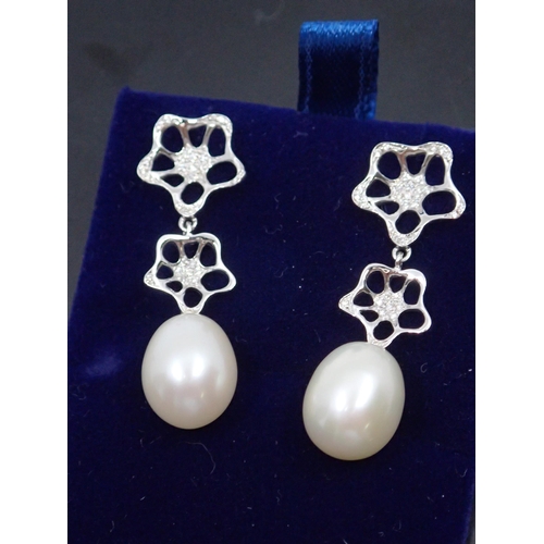 159 - A pair of 18ct gold diamond pearl earrings