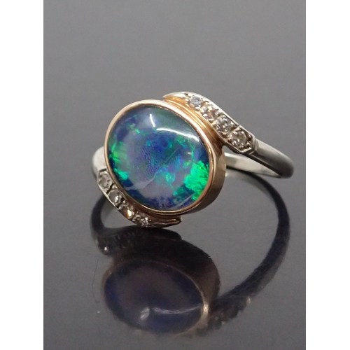 171 - An opal and diamond cluster ring, finger size Q to R set in 14kt gold