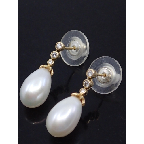 19 - A pair of pearl and diamond earrings