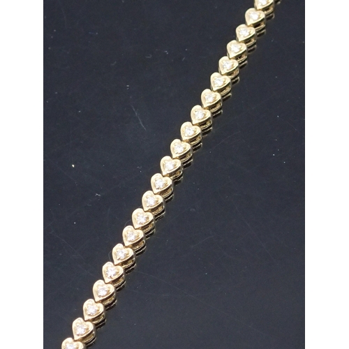 23 - A diamond line bracelet set in 14kt gold approx.11.3 grams 7 inches in length