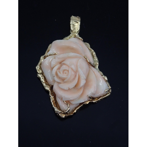 44 - A gold mounted pink flower pendant, total weight 34.7 grams