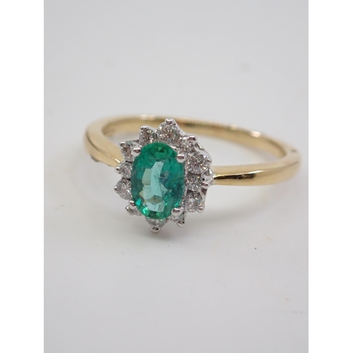 5 - An 18ct gold emerald and diamond cluster ring finger size Q