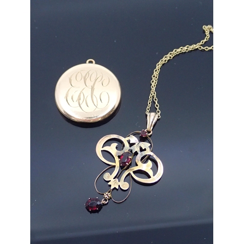 63 - A gold pendant on a chain and gold plated locket