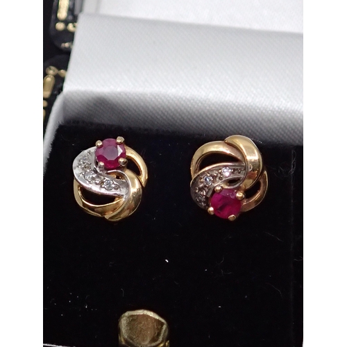 96 - A gold pair of ruby and diamond earrings