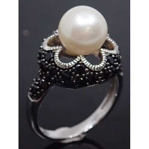 98 - A silver pearl set ring, showing as finger size N