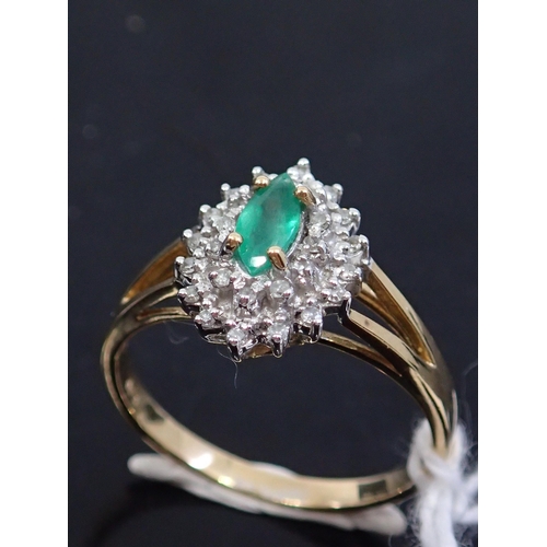 40 - An emerald and diamond cluster ring set in 9ct gold, finger size L half