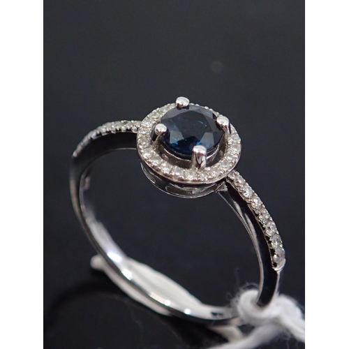 43 - A halo style diamond ring, showing as finger size M and a half