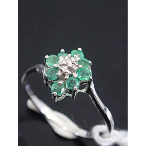 56 - A emerald ring, showing as finger size L and a half